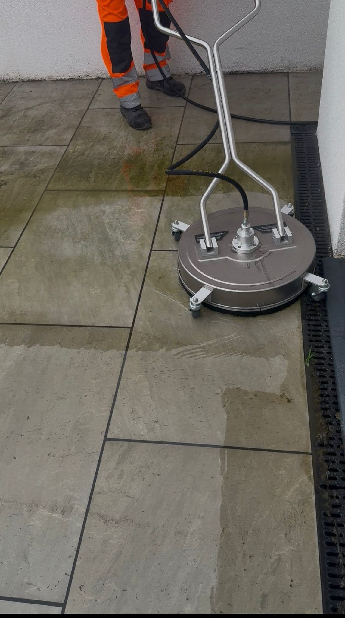 Professional patio cleaning in progress showing before and after